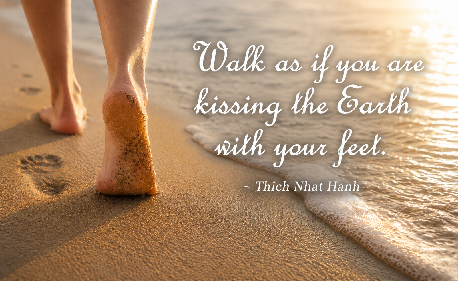 Bare feet walking mindfully along a sandy beach with a Thich Nhat Hanh quote about mindfulness
